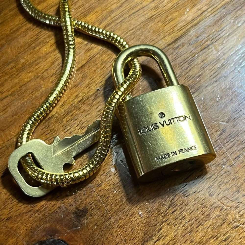 Louis Vuitton Gold Lock On off brand chain No 305 Works. Authentic